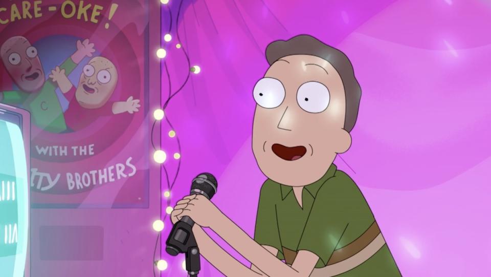 Jerry sings into a microphone on a purple stage on Rick and Morty