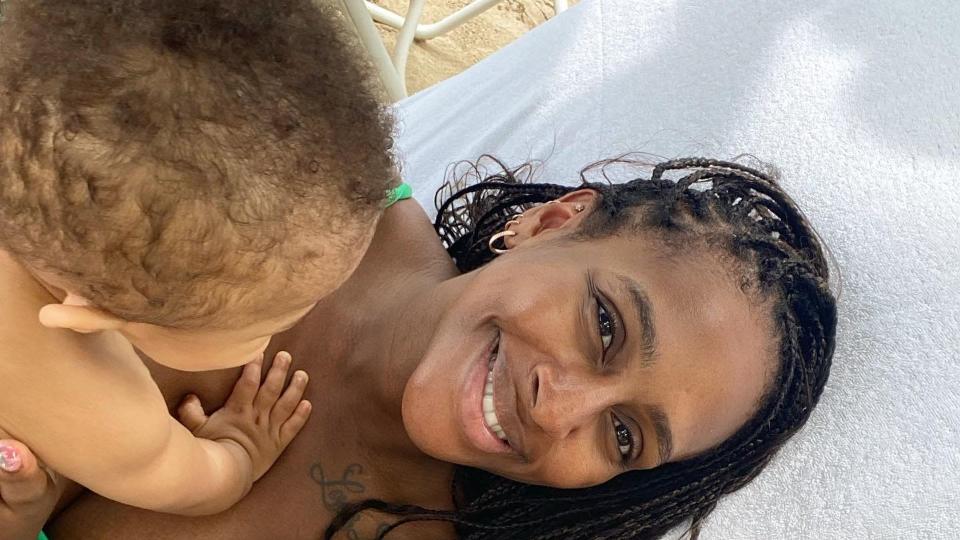 Alexandra Burke on sun lounger with baby and boyfriend