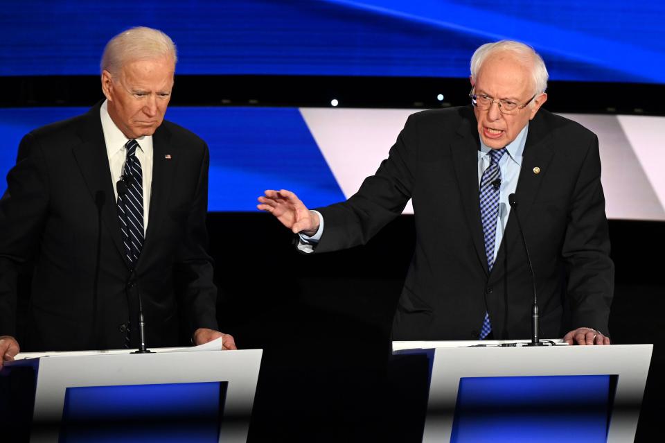 (L-R) Democratic presidential hopefuls Former Vice President Joe Biden (L) and Vermont Senator Bernie Sanders participate of the seventh Democratic primary debate of the 2020 presidential campaign season co-hosted by CNN and the Des Moines Register at the Drake University campus in Des Moines, Iowa on January 14, 2020.