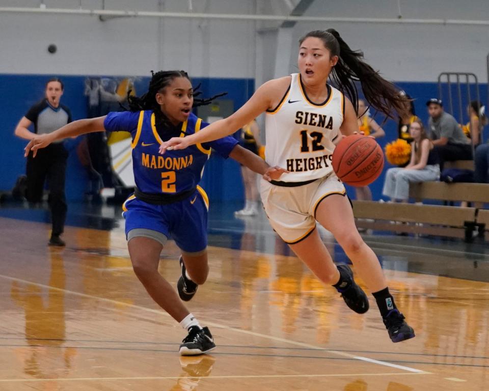 E’Anna Won of Siena Heights takes the ball to the basket against Madonna’s Brooklyn Ragland during a 79-27 Siena Heights win Wednesday night.