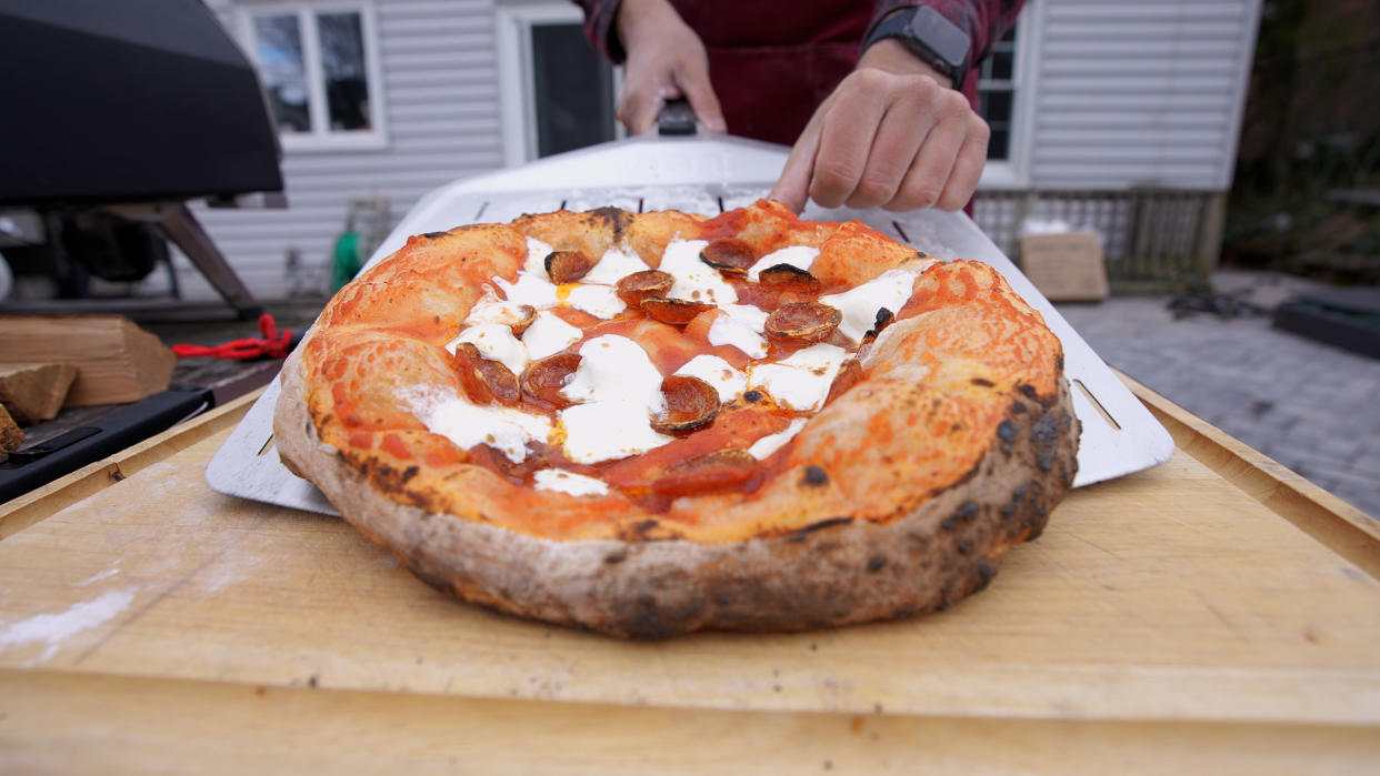  Pizza coming out of oven. 