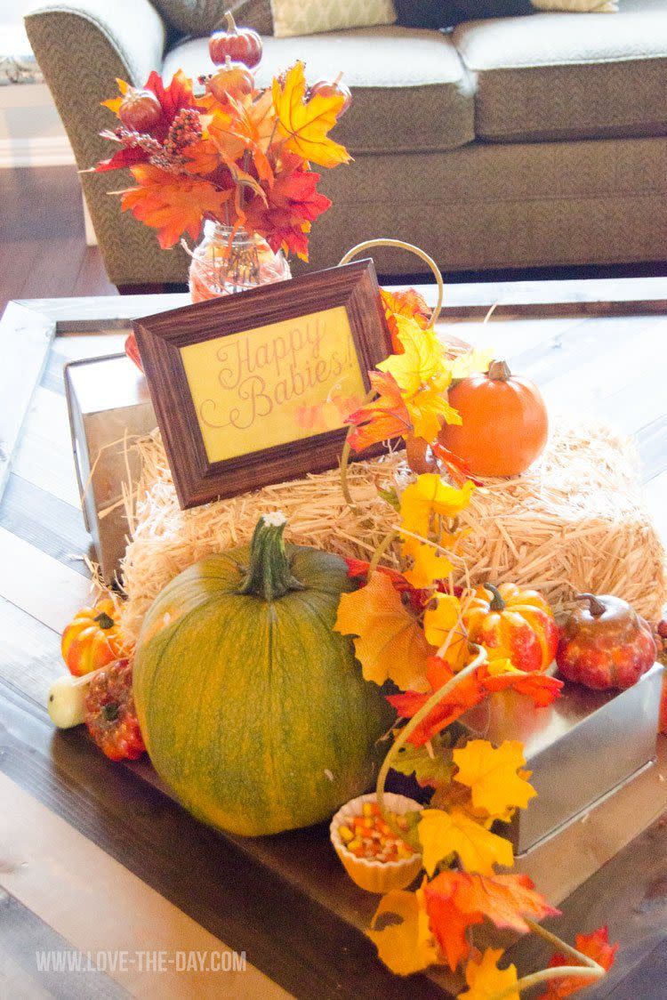 pumpkins, leaves and hay bales decorate a fall themed shower, a great baby shower idea