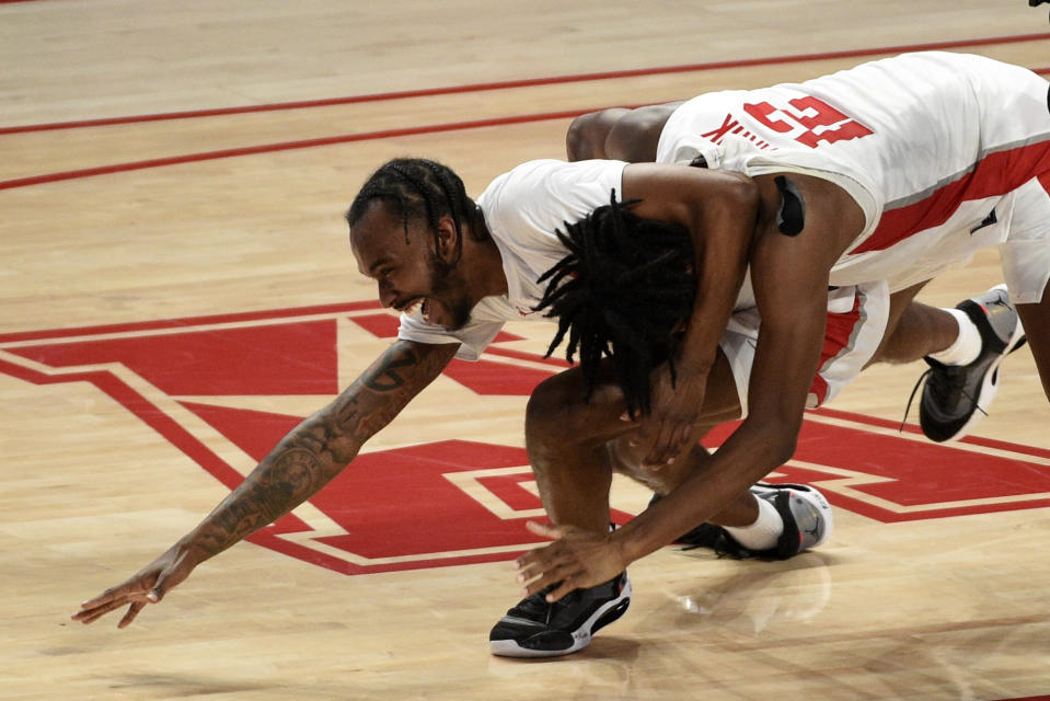 Houston guard Tramon Mark, right, celebrates his game-winning 3-point basket with DeJon Jarreau during the second half of an NCAA college basketball game against Memphis, Sunday, March 7, 2021, in Houston. (AP Photo/Eric Christian Smith)