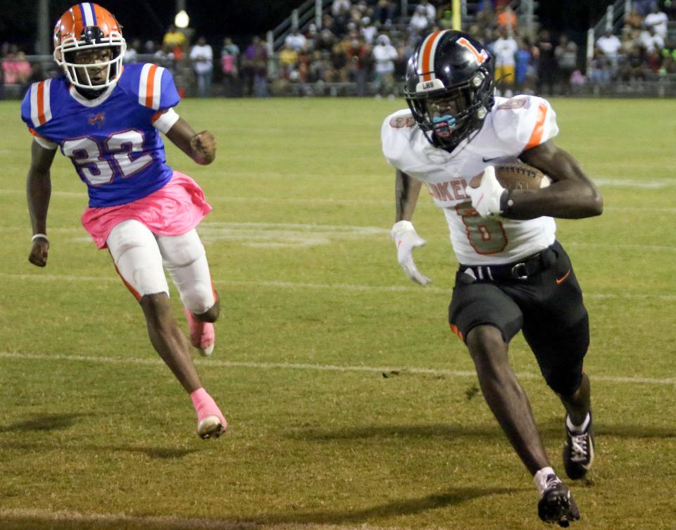 Lakeland's Daidren Zipper runs for extra yards after a catch as Bartow's Trequan Jones gives chase on Friday night in a Class 7A, District 5 game at Bartow Memorial Stadium.