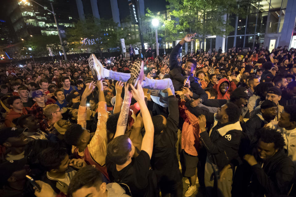 TORONTO, ON - JUNE 13: Toronto Raptors fans cheer after the team beat the Golden State Warriors in Game Six of the NBA Finals, during a viewing party in Jurassic Park outside of Scotiabank Arena on June 13, 2019 in Toronto, Canada. (Photo by Cole Burston/Getty Images)