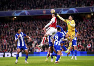 Porto goalkeeper Diogo Costa, right, punches the ball clear during the Champions League round of 16, second leg soccer match between Arsenal and Porto at the Emirates Stadium, London, Tuesday March 12, 2024. (Zac Goodwin/PA via AP)