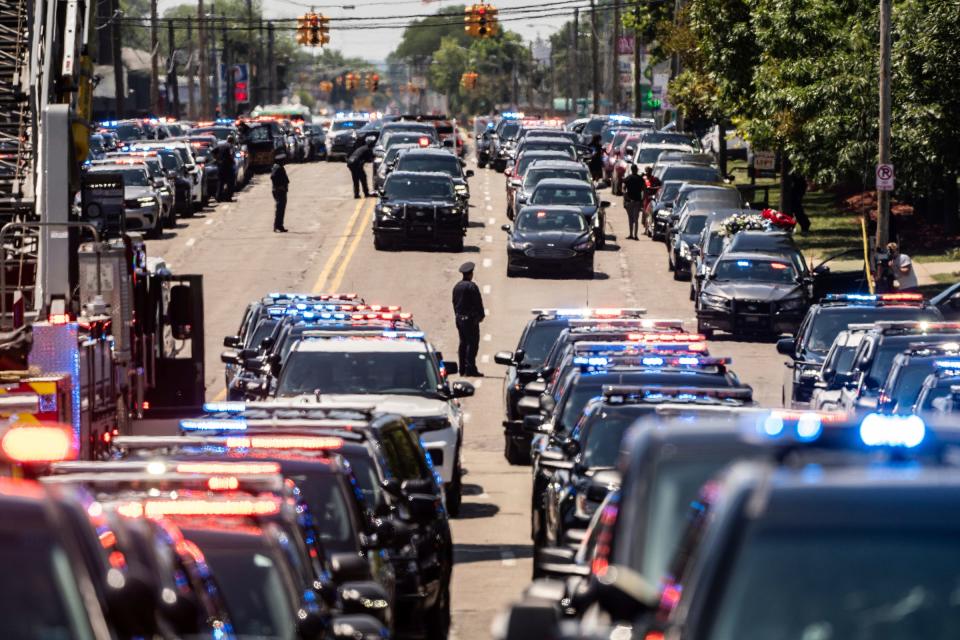 Vehicles wait for the procession to leave Greater Grace Temple in Detroit on Monday, July 18, 2022, at the end of the funeral for fallen Detroit Police Officer Loren Courts.