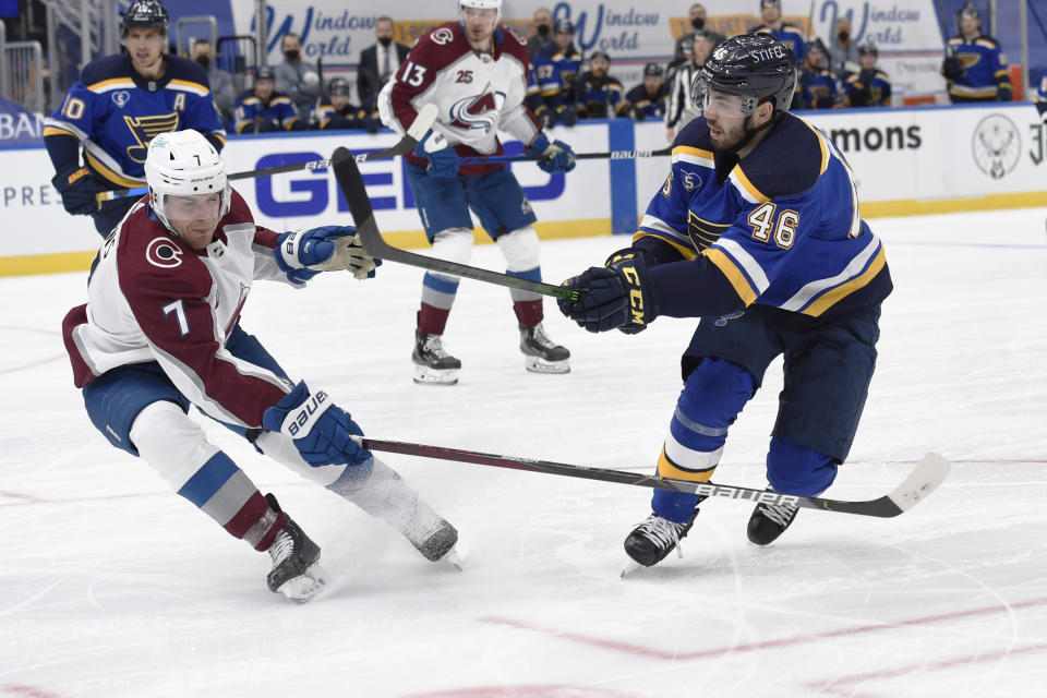 Colorado Avalanche's Devon Toews (7) attempts to block a shot from St. Louis Blues' Jake Walman (46) during the second period of an NHL hockey game on Wednesday, April 14, 2021, in St. Louis. (AP Photo/Joe Puetz)