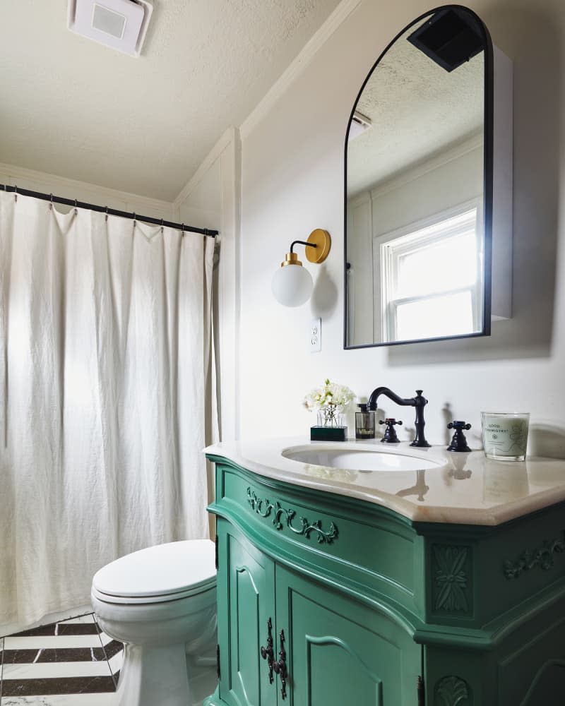 Green vanity in bathroom after renovation.