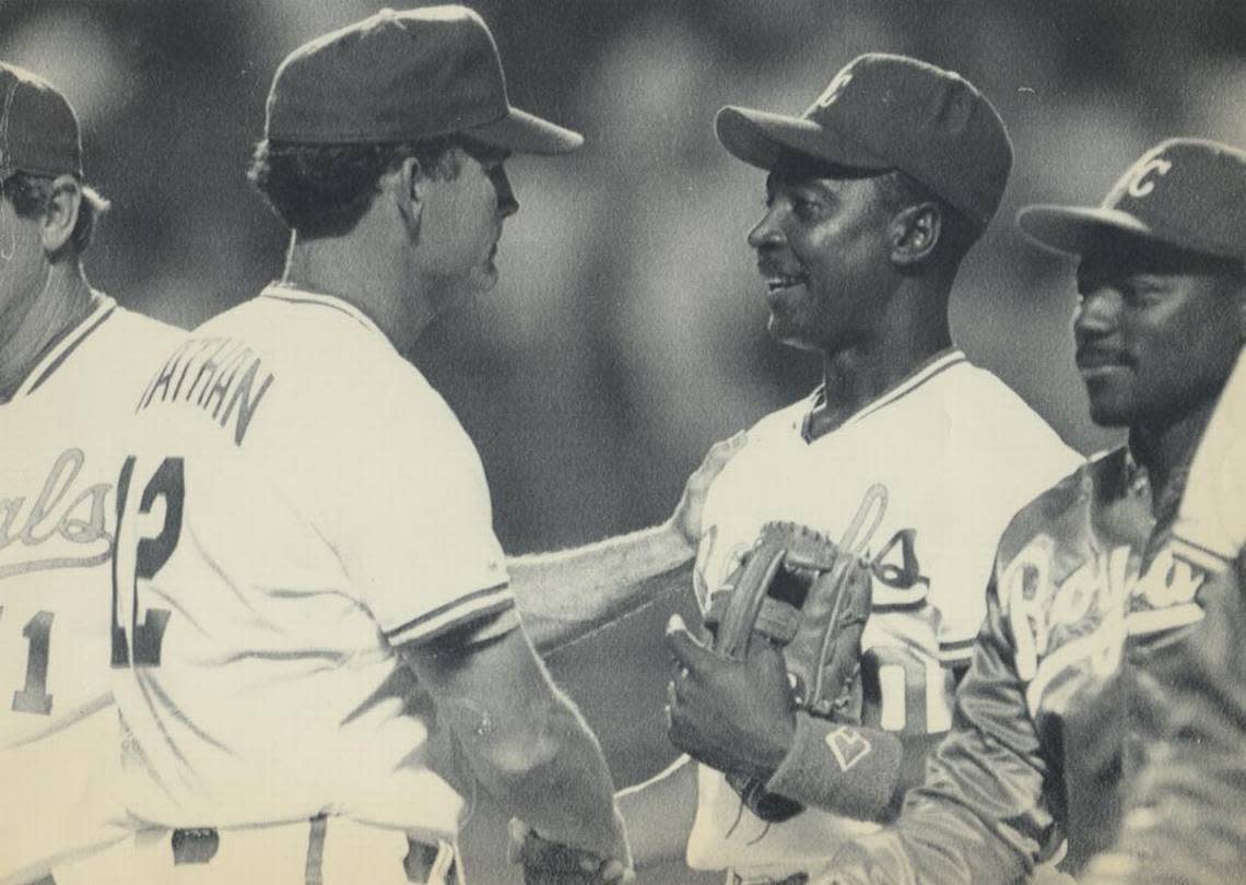 FILE: Frank White (second from right) with former Royals manager John Wathan after a 1990 game.