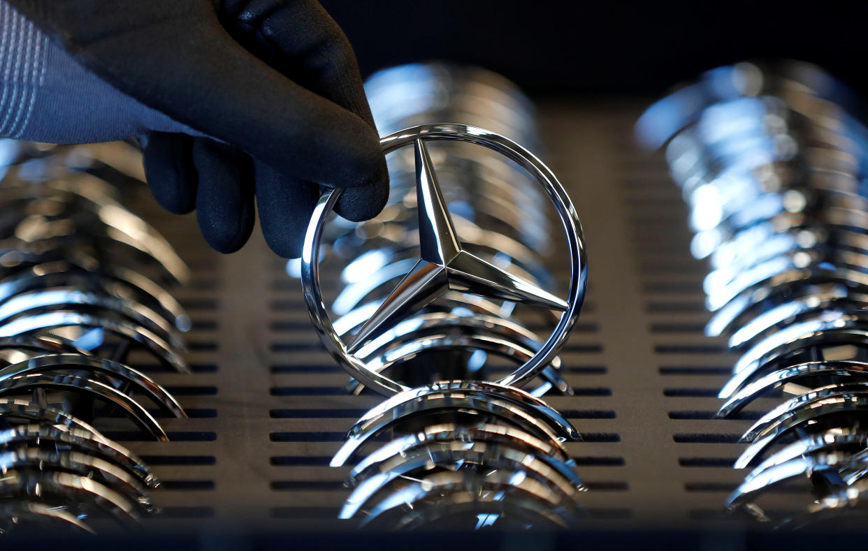 An employee of German car manufacturer Mercedes Benz prepares the company's logo prior to its installation at the A-class production line at the Daimler factory in Rastatt, Germany, February 4, 2019.  REUTERS/Kai Pfaffenbach