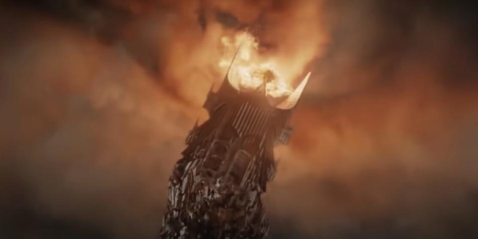 A tower collapsing, with the flaming Eye of Sauron on top of it.