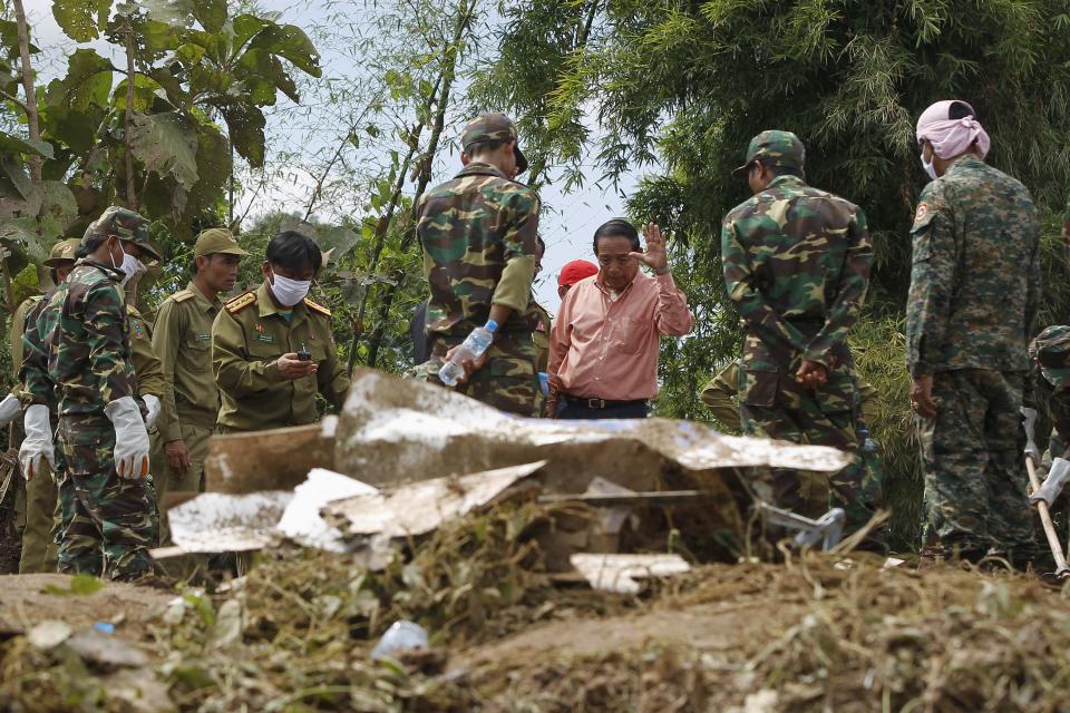 Rescue personnel work at the crash site of an ATR-72 turboprop plane, in Laos, near Pakse