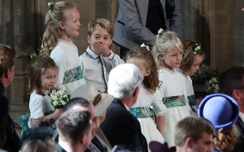 The bridesmaids and page boys, including cheeky Prince George, wait for the ceremony to start - Credit: PA