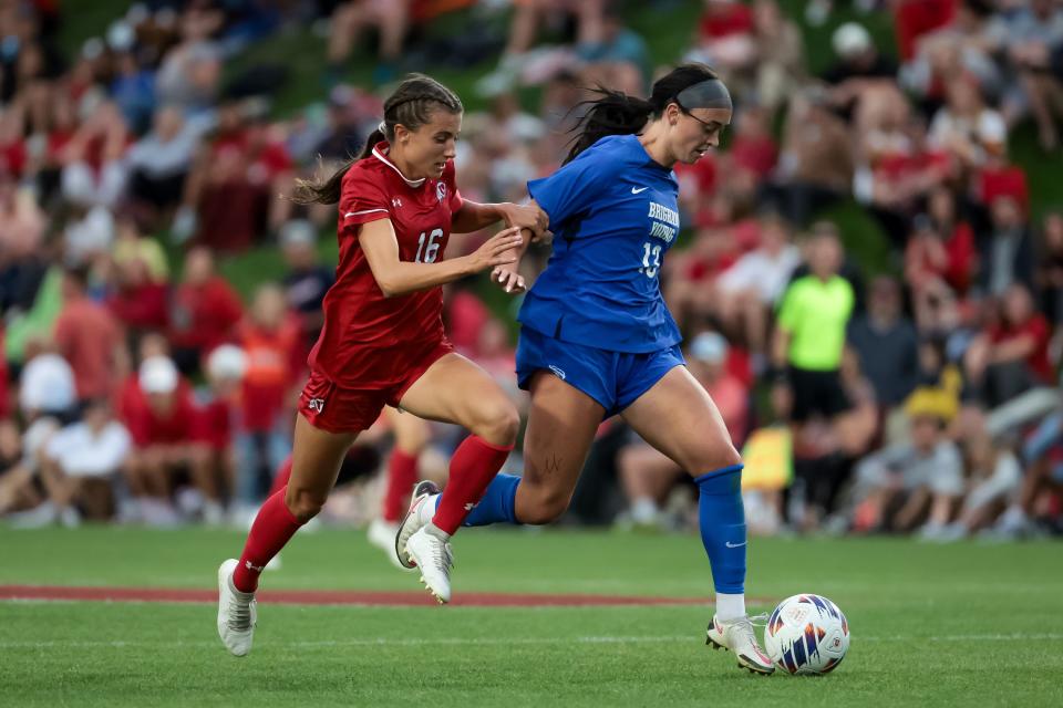 BYU’s Brecken Mozingo (13) moves the ball ahead of Utah’s Courtney Brown (16) during the game at Ute Field in Salt Lake City on Saturday, Sept. 9, 2023. | Spenser Heaps, Deseret News