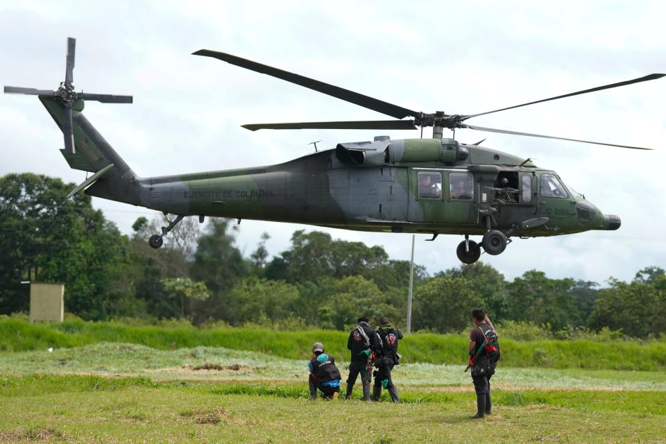 A military helicopter takes off with a group of Indigenous persons at a military base in Calamar, Colombia, on May 23, 2023, to help search for four Indigenous children who are missing after a deadly plane crash.