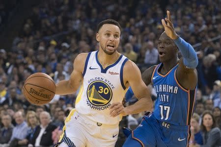 October 16, 2018; Oakland, CA, USA; Golden State Warriors guard Stephen Curry (30) dribbles the basketball against Oklahoma City Thunder guard Dennis Schroder (17) during the first quarter at Oracle Arena. Mandatory Credit: Kyle Terada-USA TODAY Sports