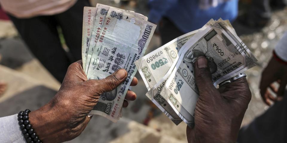 A man counts Indian rupee banknotes in Varanasi, Uttar Pradesh, India.