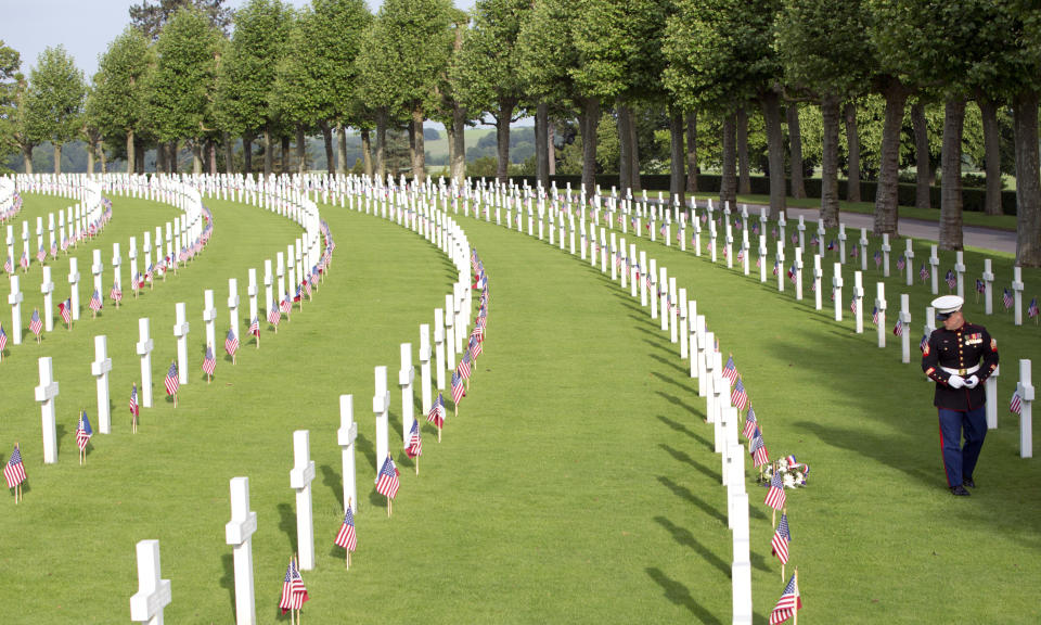 FILE -A United States Marine walks among graves at the Aisne-Marne American Cemetery in Belleau, France, on May 27, 2018. With war ravaging Europe's heartland again, the countless headstones, cemeteries and memorials from World War I are a timeless testimony to its cruelty. Belgium and France want them recognized as UNESCO World Heritage sites to make sure people stop and think. (AP Photo/Virginia Mayo, File)