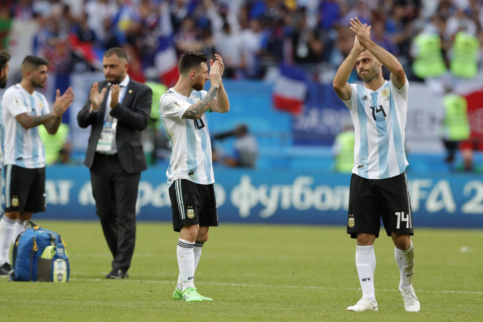 Argentina’s Lionel Messi, center, and Argentina’s Javier Mascherano, right, acknowledge the fans at the end of the round of 16 match between France and Argentina, at the 2018 soccer World Cup at the Kazan Arena in Kazan, Russia, Thursday, June 28, 2018. (AP Photo/Ricardo Mazalan)