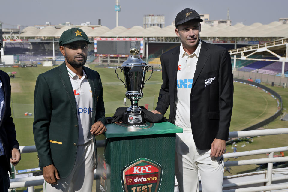 Pakistani skipper Babar Azam, left, and his New Zealand's counterpart Tim Southee pose for a photo with the test series trophy, in Karachi, Pakistan, Sunday, Dec. 25, 2022. (AP Photo/Fareed Khan)