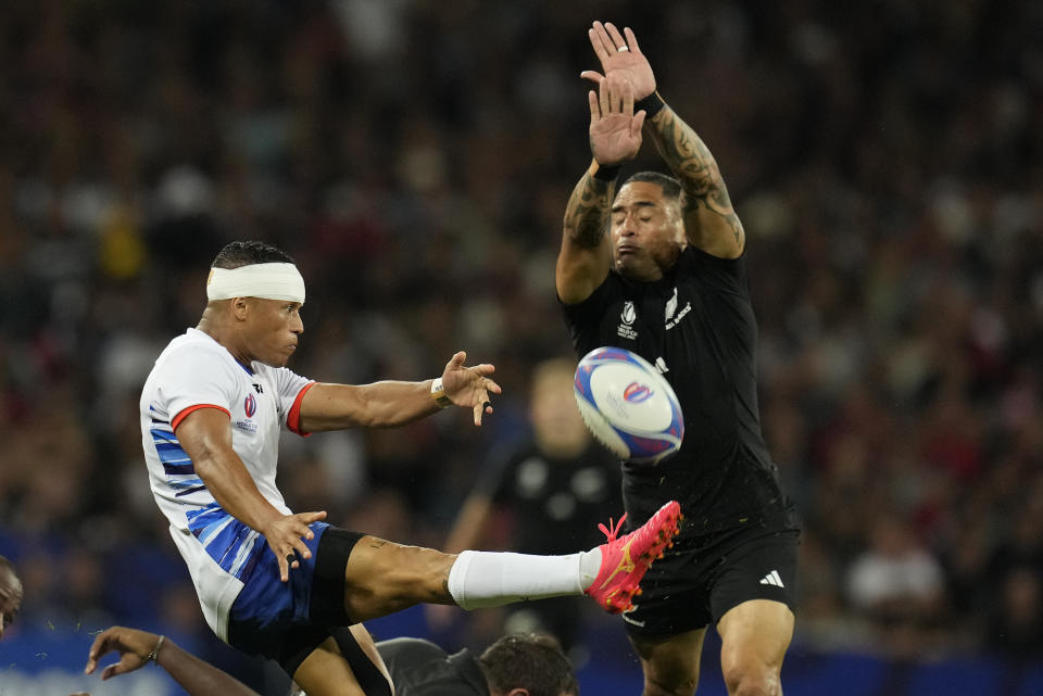 Namibia's Damian Stevens clears the ball as New Zealand's Aaron Smith tries to block during the Rugby World Cup Pool A match between New Zealand and Namibia at the Stadium de Toulouse in Toulouse, France, Friday, Sept. 15, 2023. (AP Photo/Themba Hadebe)