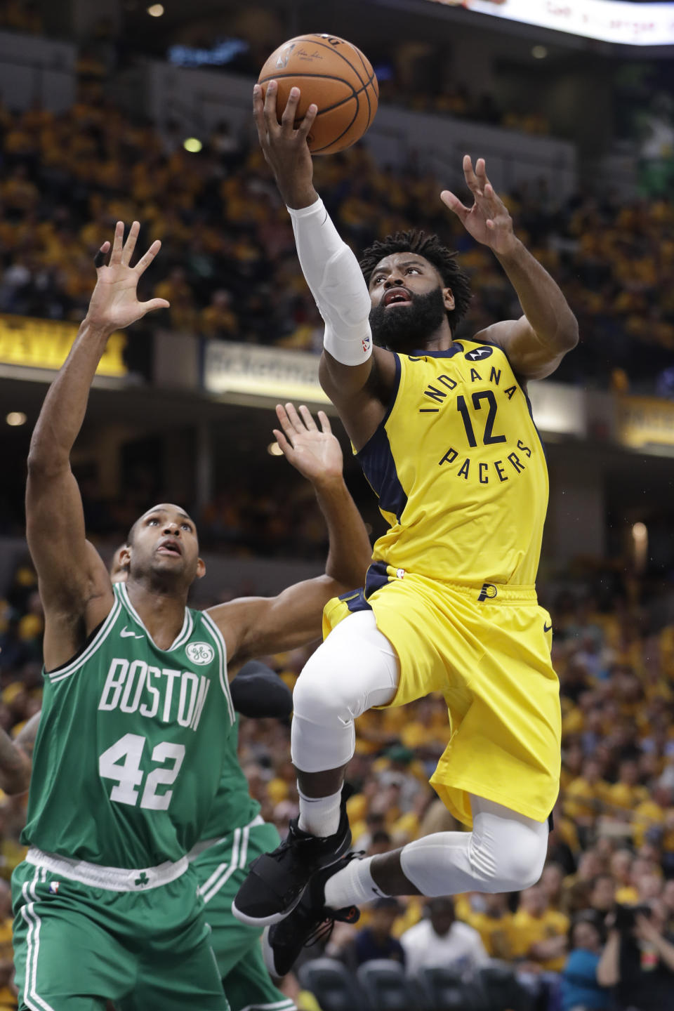 Indiana Pacers guard Tyreke Evans (12) shoots in front of Boston Celtics center Al Horford (42) during the first half of Game 3 of an NBA basketball first-round playoff series Friday, April 19, 2019, in Indianapolis. (AP Photo/Darron Cummings)