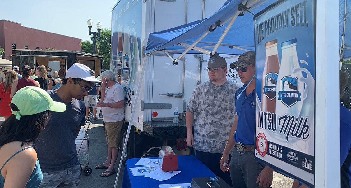 Customers attending the Murfreesboro Saturday Market on June 25 study the milk options available for sale at the MTSU Creamery location outside the Rutherford County Courthouse in downtown Murfreesboro. The market is from 8 a.m. to noon every Saturday through Oct. 30.