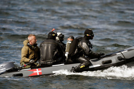 Divers from the Danish Defence Command prepare for a dive in Koge Bugt near Amager in Copenhagen, Denmark August 22, 2017. Scanpix Denmark/Liselotte Sabroe via REUTERS