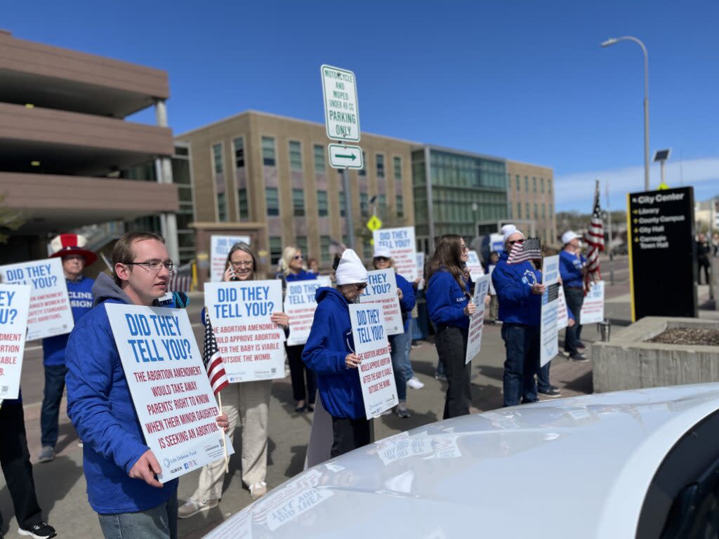 People associated with the Life Defense Fund protest outside a Sioux Falls library on May 1, 2024, as an abortion-rights group conducts a press conference inside. (Joshua Haiar/South Dakota Searchlight)