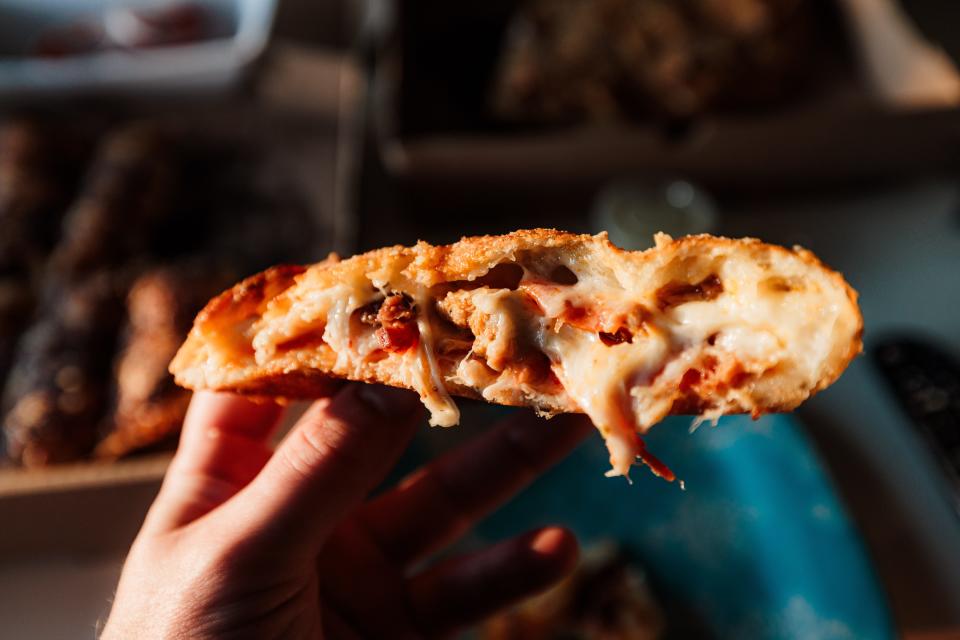 The calzone from Dameon's Pizza was thick, cheesy slice stuffed with sausage, pepperoni, and beef — delicious and filling.