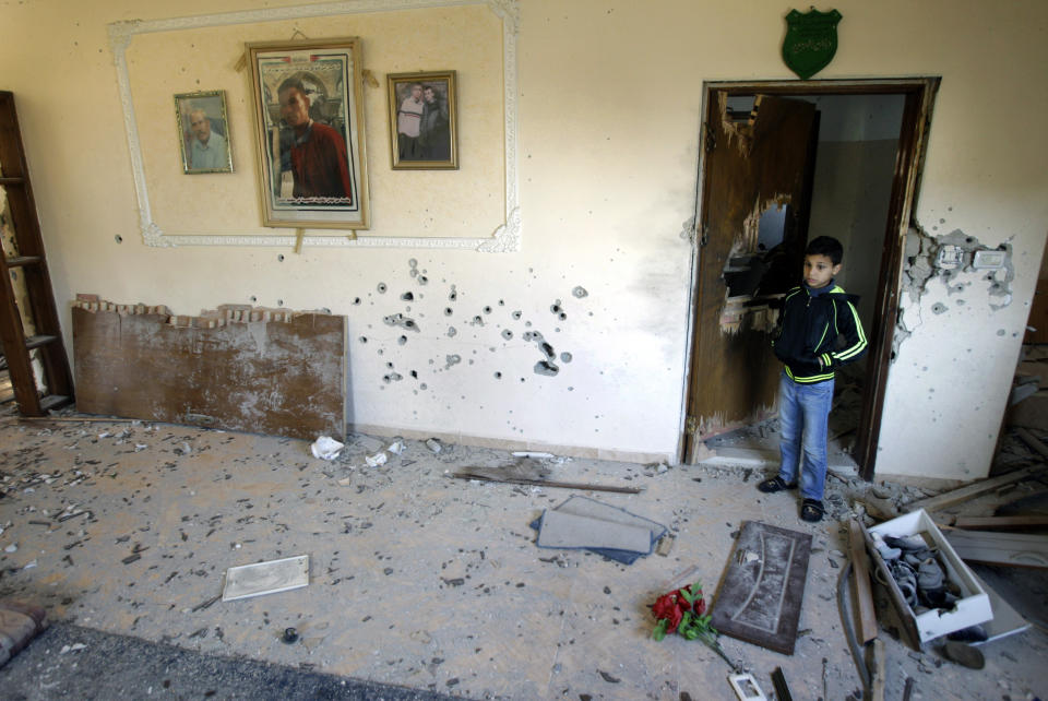 A Palestinians child stands inside the home of Hamza Abu el-Heija, where he was killed by Israeli troops, in the West Bank refugee camp of Jenin, Saturday, March 22, 2014. Israeli troops killed at least four Palestinians in an early morning raid that was followed by a clash with angry protesters in a West Bank town on Saturday, the Israeli military and Palestinian security officials said, in the deadliest incident in months. The Israeli raid, which the military said aimed to arrest Hamza Abu el-Heija, a 22-year-old Hamas operative wanted for involvement in shooting and bombing attacks against Israelis. (AP Photo/Mohammed Ballas)