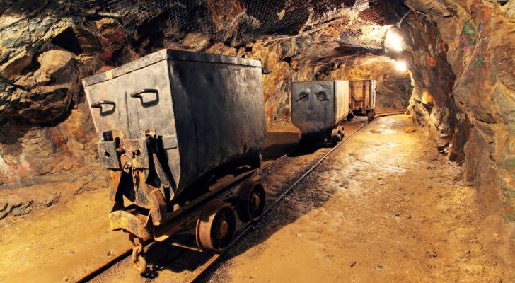 a cart filed with gold in a gold mine