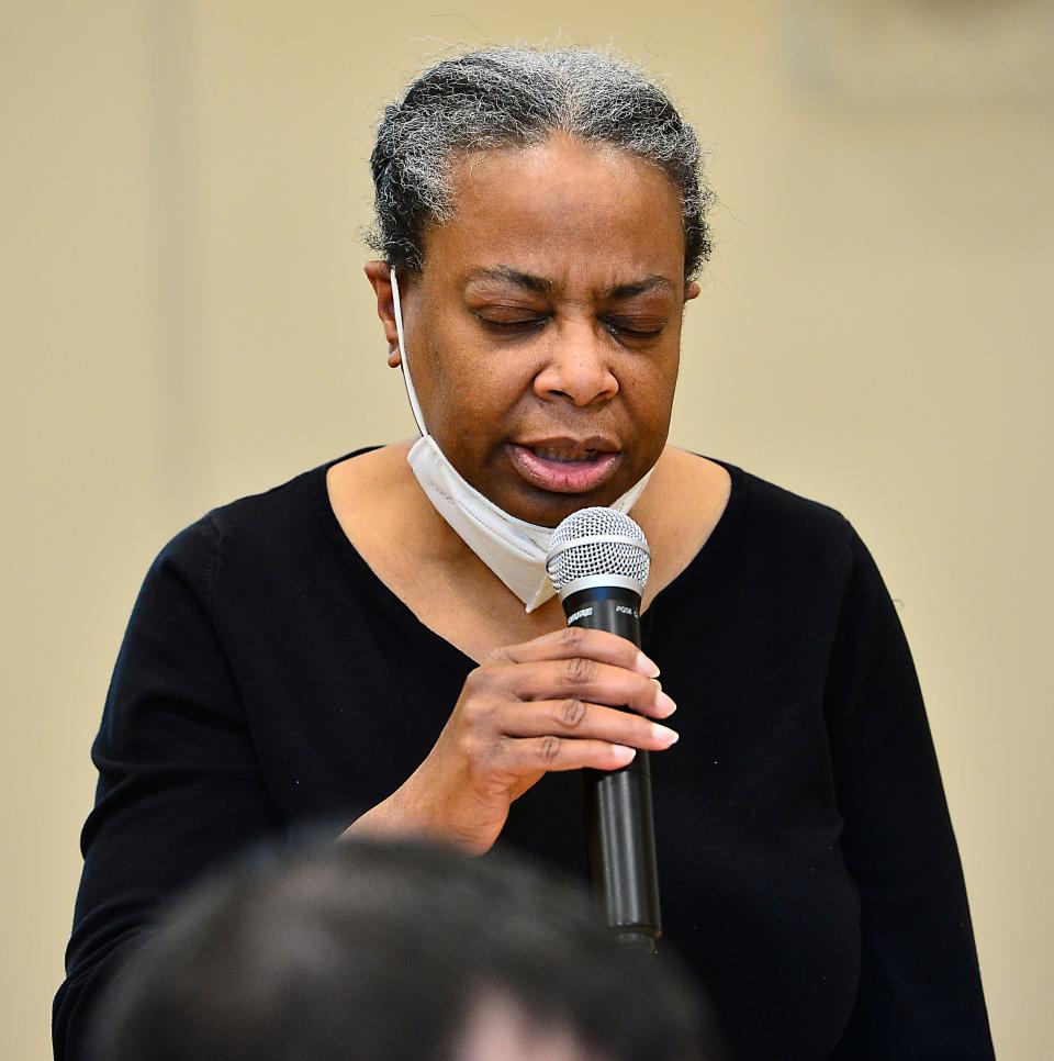 Spartanburg residents spoke out against gun violence and how to help young people at the C.C. Woodson Community Center in Spartanburg on Saturday. Toni Brown of Spartanburg said a prayer at the event.