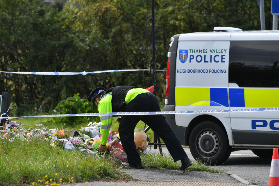 A police officer lays a floral tribute at the scene, where Thames Valley Police officer Pc Andrew Harper, 28, died following a "serious incident" at about 11.30pm on Thursday near the A4 Bath Road, between Reading and Newbury, at the village of Sulhamstead in Berkshire.