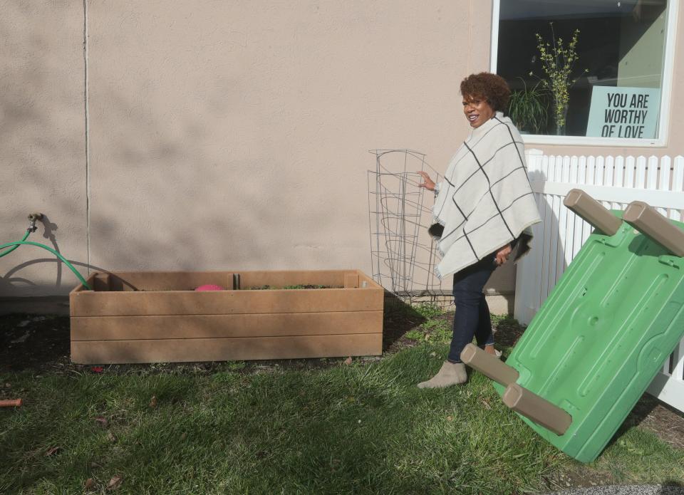 Battered Women's Shelter Executive Director Teresa Stafford shows a small raised garden used by residents at the Akron shelter.