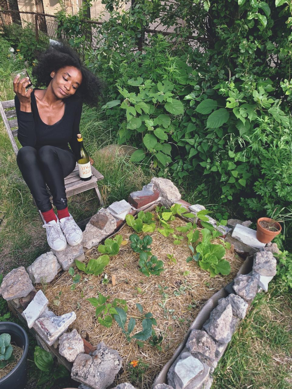 Brionna Jimerson sits by one of her raised garden beds in Brooklyn, N.Y. "There is something inherently powerful about being able to produce and cultivate something with your own two hands," Jimerson says.