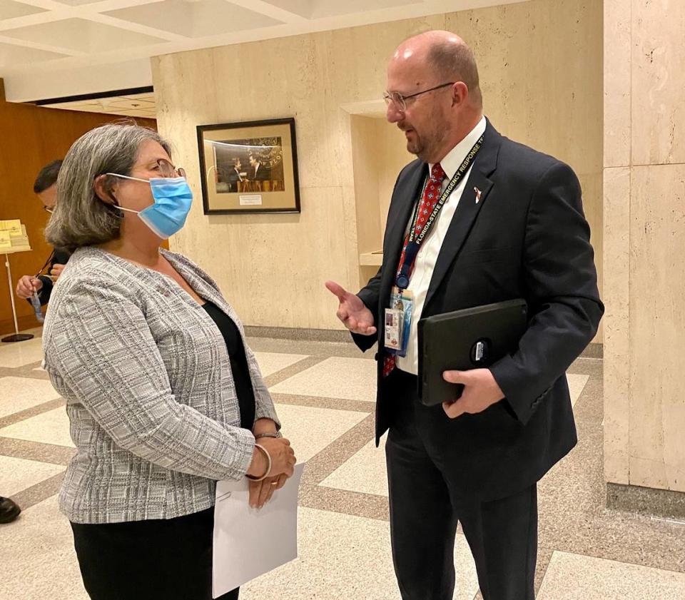 Miami-Dade County Mayor Daniella Levine Cava talks to Emergency Management Director Kevin Guthrie in the Florida Capitol on Tuesday, Jan. 11, 2022, in Tallahassee.