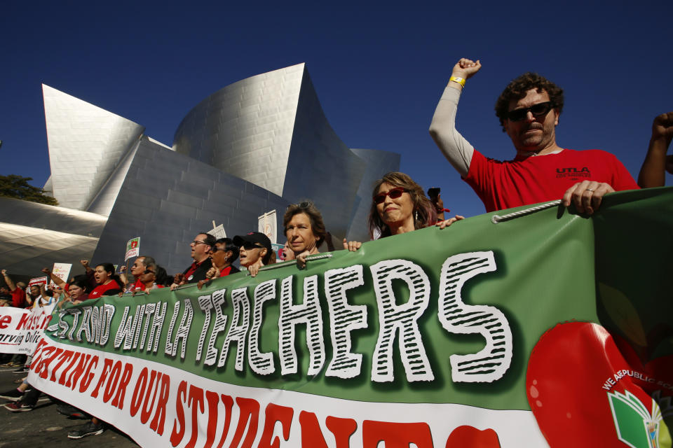 In this Saturday, Dec. 15, 2018 photo, thousands of teachers rally against the nation's second-largest school district in downtown Los Angeles. A massive teachers strike in Los Angeles is all but inevitable starting Monday, Jan. 14, 2019, after the two sides did not renew negotiations over the weekend. The teachers' union rejected a new offer Friday from the LA Unified School District after hours of talks. United Teachers Los Angeles called the district proposal "woefully inadequate." With no new talks scheduled, pickets are likely to begin at 7 a.m. as teachers push for a raise and lower class sizes. (AP Photo/Damian Dovarganes)