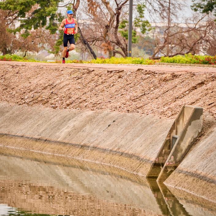 Marathon runner Ricky Aponte runs along the Crosscut Canal Path during the Rock ’n’ Roll Marathon in Tempe on Jan. 15, 2023.