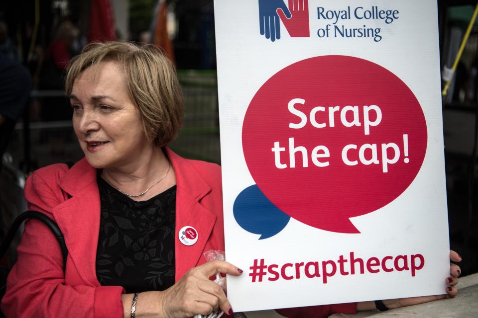 A woman holds a placard during a nurses protest outside Downing Street on July 27, 2017 in London, England (Photo by Carl Court/Getty Images)