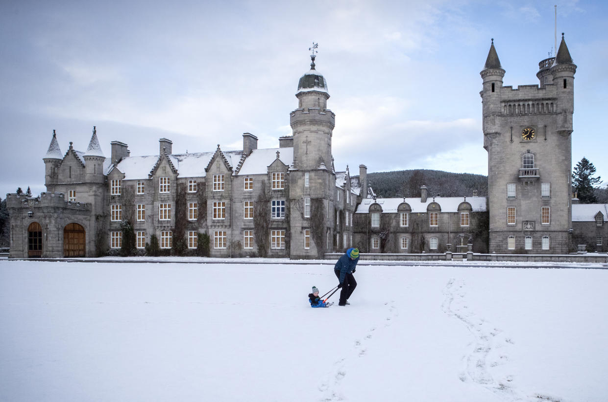 Geraint Stone pulls his two-year-old son Arthur on his sledge across the snow-covered lawn in front of Balmoral Castle, Royal Deeside. The Met Office has issued a yellow weather warning for ice and snow across Scotland. (Photo by Jane Barlow/PA Images via Getty Images)