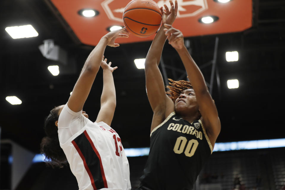 Stanford guard Indya Nivar, left, blocks a shot by Colorado guard Jaylyn Sherrod (00) during the second quarter of an NCAA college basketball game in Stanford, Calif., Sunday, Jan. 22, 2023. (AP Photo/Jim Gensheimer)