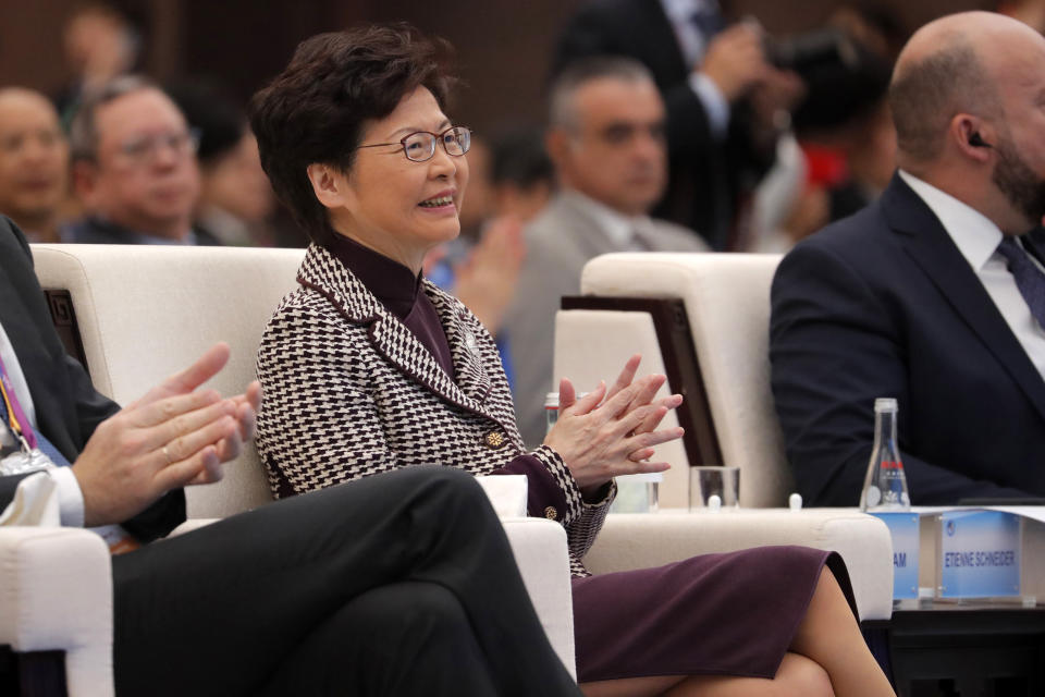 Hong Kong Chief Executive Carrie Lam claps as she attends the second Hongqiao International Economic Forum of the 2nd China International Import Expo at the National Exhibition and Convention Center in Shanghai, China, Tuesday, Nov. 5, 2019. (Wu Hong/Pool Photo via AP)