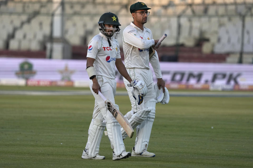 Pakistan's Saud Shakeel, left, and Abrar Ahmed walk off the field on the end of the third day play of the second test cricket match between Pakistan and New Zealand, in Karachi, Pakistan, Wednesday, Jan. 4, 2023. (AP Photo/Fareed Khan)
