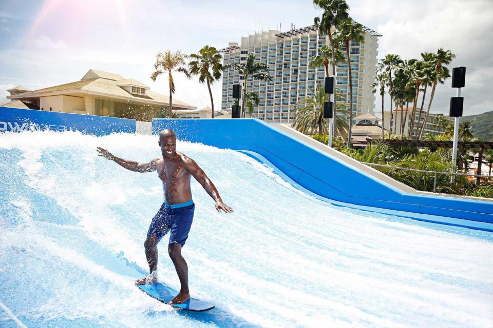 A man rides on a surfing simulator at the Moon Palace Jamaica resort