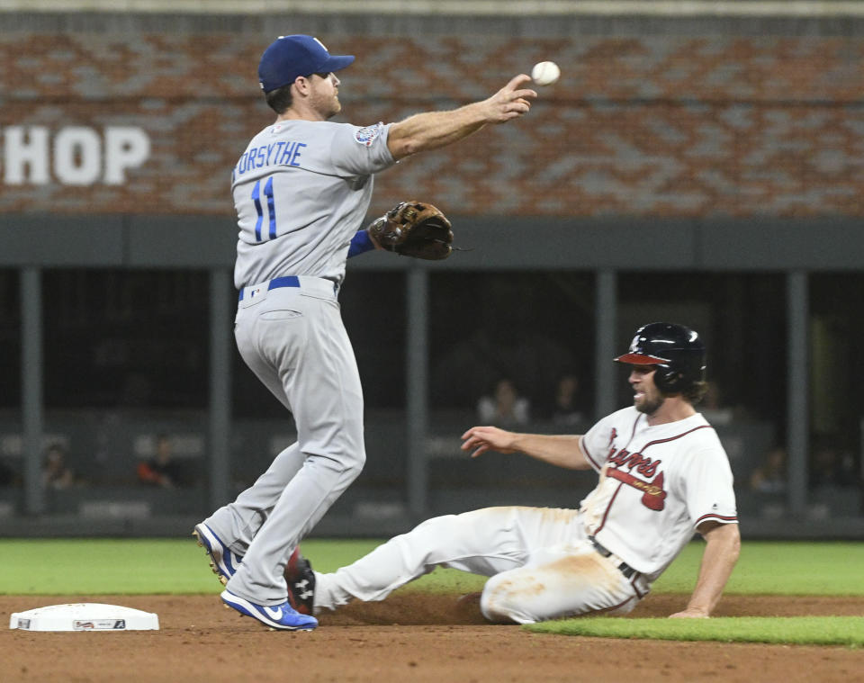 Los Angeles Dodgers second baseman Logan Forsythe throws out Atlanta Braves' Nick Markakis at first base after forcing out Charlie Culberson, right, at second base during the eighth inning of a baseball game Saturday, July 28, 2018, in Atlanta. (AP Photo/John Amis)