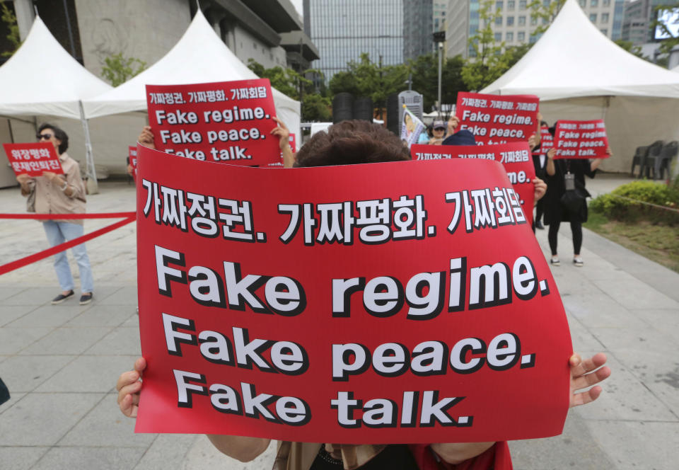 FILE - In this Sept. 19, 2018, file photo, South Korean protesters hold banners during a rally against the summit between South Korean President Moon Jae-in and North Korean leader Kim Jong Un near the U.S. embassy in Seoul, South Korea. South Korea declared a crackdown against supposed “fake news” flourishing online, vowing to use its criminal laws to curb what officials here have proclaimed a threat to democracy. Some experts say Moon’s government is becoming increasingly sensitive about public opinion as it desperately tries to keep optimism alive for its fragile diplomacy with North Korea. (AP Photo/Ahn Young-joon. File)