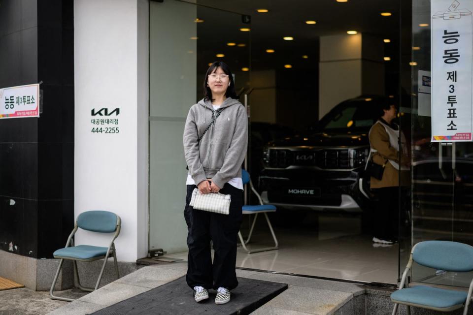 Choi Ji-sun, 25, exhibition designer, poses outside a polling station in Seoul on 10 April 2024, after voting during the parliamentary election (AFP via Getty Images)