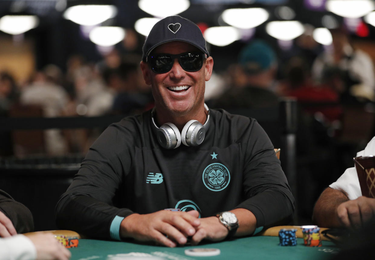 FILE - Former Australian cricket player Shane Warne plays during the first day of the World Series of Poker main event July 3, 2019, in Las Vegas. Shane Warne, one of the greatest cricket players in history, has died. He was 52. Fox Sports television, which employed Warne as a commentator, quoted a family statement as saying he died of a suspected heart attack in Koh Samui, Thailand. (AP Photo/John Locher)